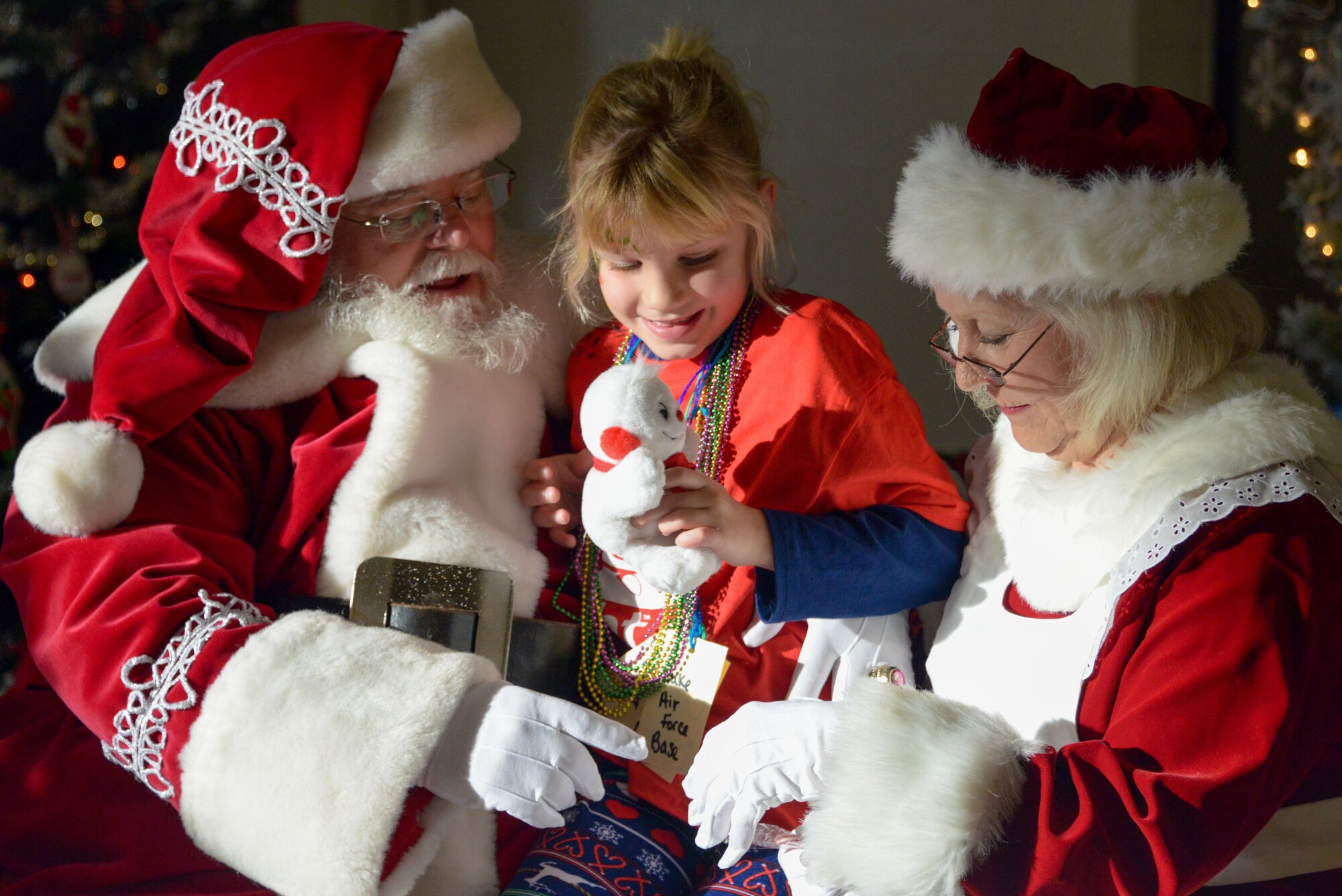 A Team Luke child speaks with Mr. and Mrs. Santa Claus during the United Fantasy Flight at Phoenix Ariz., Dec. 1, 2017. Several children from Luke, who have a family member currently deployed, were invited to the special event. The North Pole experience included festive activities, games, holiday treats and a visit from Santa Claus. (U.S. Air Force photo/Senior Airman Devante Williams)