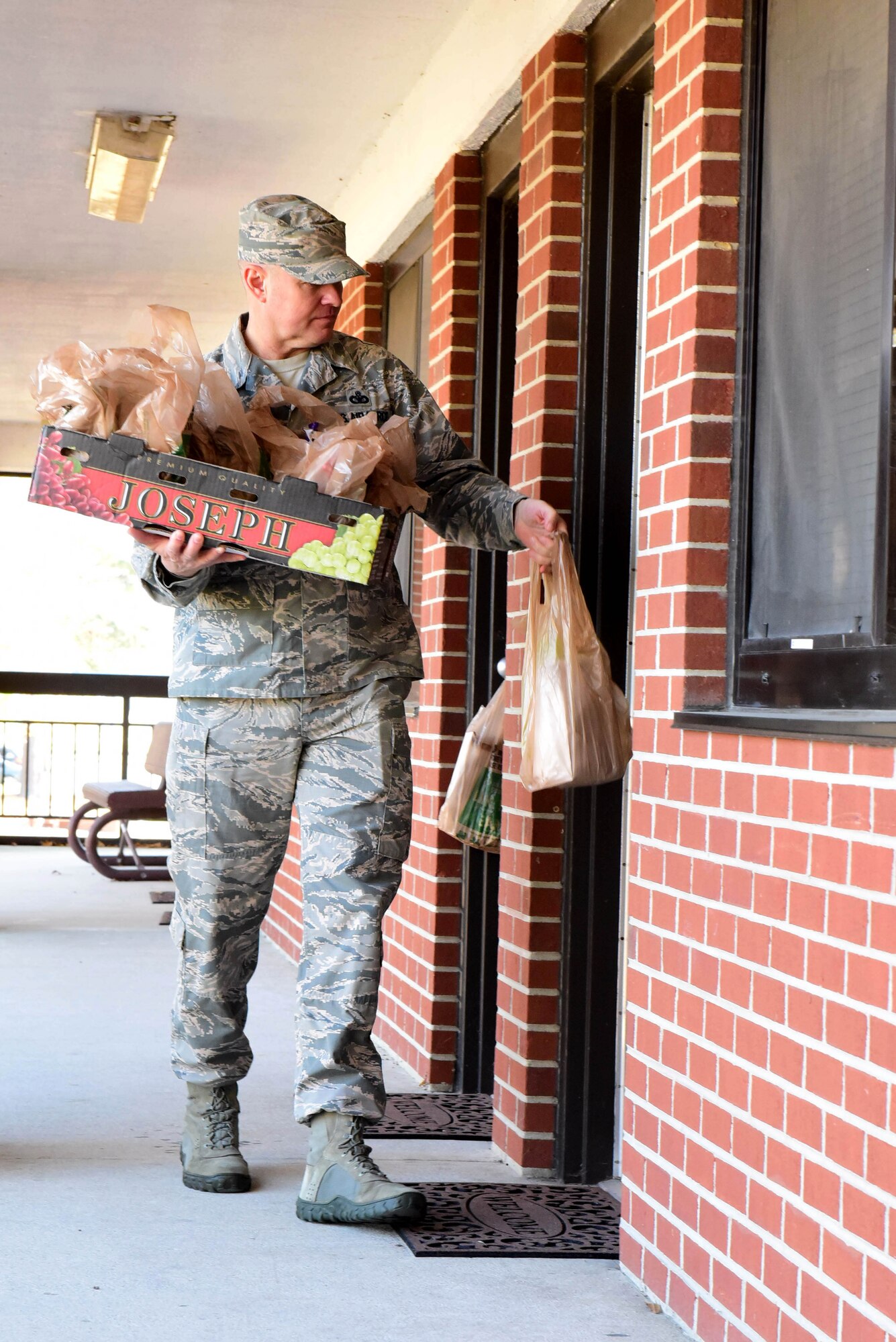 Master Sgt. Doug Harriman, 4th Civil Engineer Squadron first sergeant, delivers packets of cookies during the annual Officer and Civilian Spouses Club Airmen Cookie Drive Dec. 4, 2017, at Seymour Johnson Air Force Base, North Carolina.