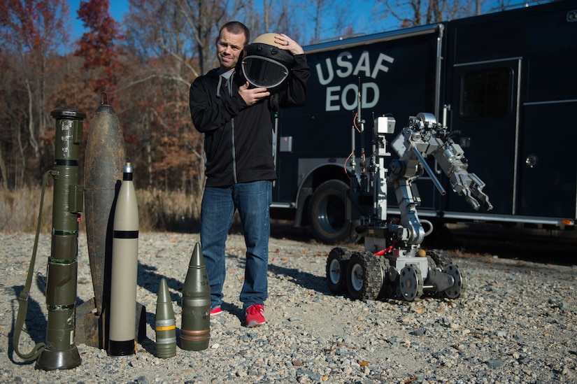 Jens Pulver, former Ultimate Fighting Championship lightweight fighter champion, poses next to 633rd Civil Engineer Squadron explosive ordinance disposal equipment during the Mixed Martial Arts Legends Tour at Joint Base Langley-Eustis, Va., Dec. 1, 2017.