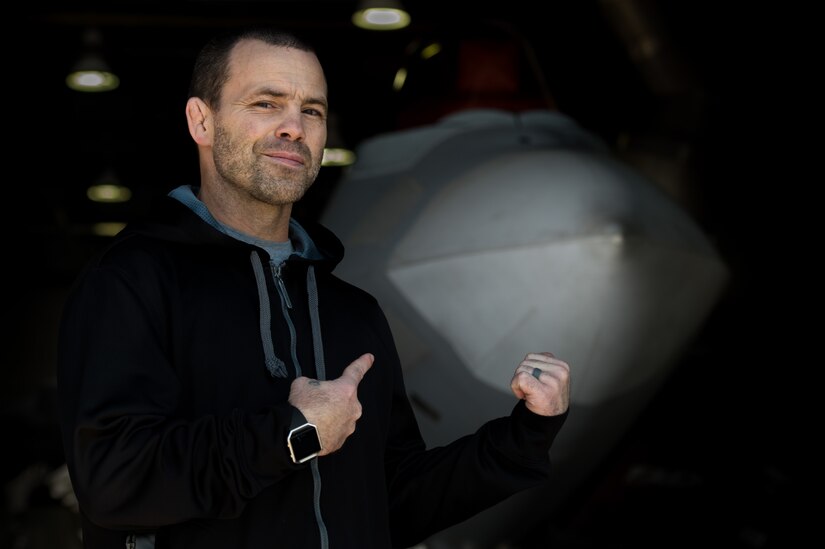 Jens Pulver, former Ultimate Fighting Championship lightweight fighter champion, poses in front of a U.S. Air Force F-22 Raptor during the Mixed Martial Arts Legends Tour at Joint Base Langley-Eustis, Va., Dec. 1, 2017.