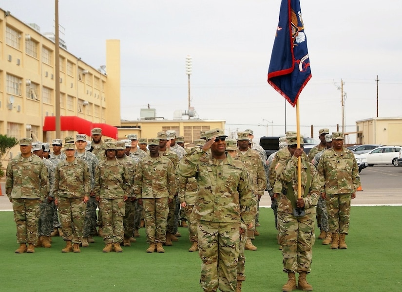 Lt. Col. Adrian Jackson salutes as he leads the incoming 7th Personnel Service Battalion, 95th Regiment, 4th Brigade, 94th Training Division, 80th Training Command formation at the CONUS Replacement Center Transfer of Authority ceremony at Fort Bliss, Texas, Dec. 1, 2017.