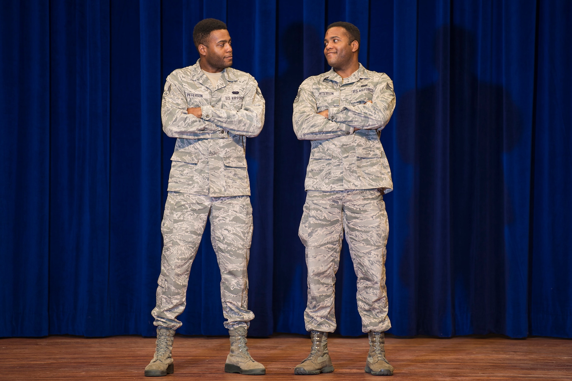 Senior Airman Jarrod Peterson (left) glances at his twin brother, Staff Sgt. Jordan Peterson, as the two pose for a photo during a photo shoot at Patrick AFB, Fla., Nov. 30, 2017.   The Peterson brothers are not only assigned to the same wing and squadron; they are also in the same flight at the Air Force Technical Applications Center. (U.S. Air Force photo by Matthew S. Jurgens)