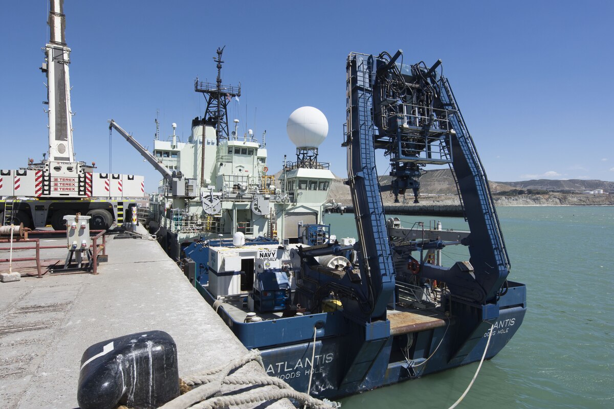 A ship is loaded with the cable-controlled Undersea Recovery Vehicle.