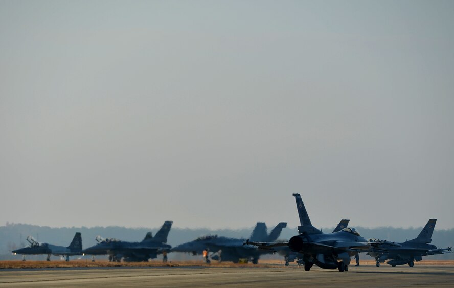 A U.S. Air Force F-16CM Fighting Falcon taxis along the runway to join sister service aircraft during basic fighter maneuver (BFM) training at Shaw Air Force Base, S.C., Dec. 1, 2017.