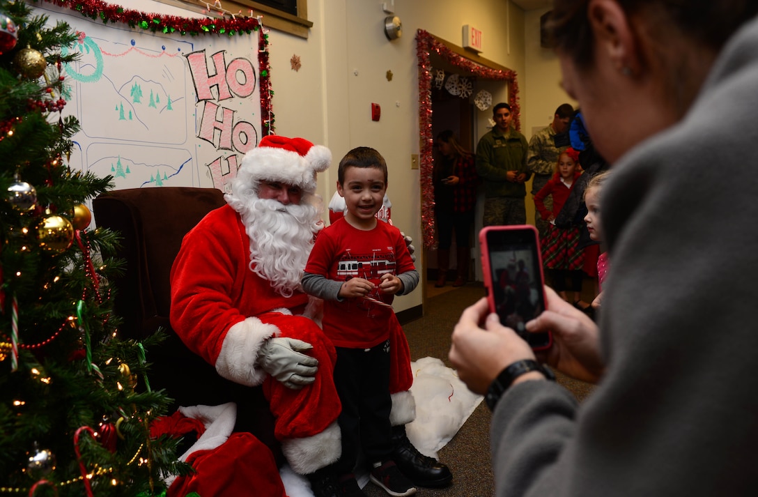 Children line up to meet Santa Claus and tell him what they want for Christmas during the Base Holiday Tree Lighting Ceremony at Ellsworth Air Force Base, S.D., Dec. 1, 2017. The 28th Bomb Wing Chapel provided refreshments, cookies and candy canes to the children and families who attended the event. (U.S. Air Force photo by Airman 1st Class Donald C. Knechtel)