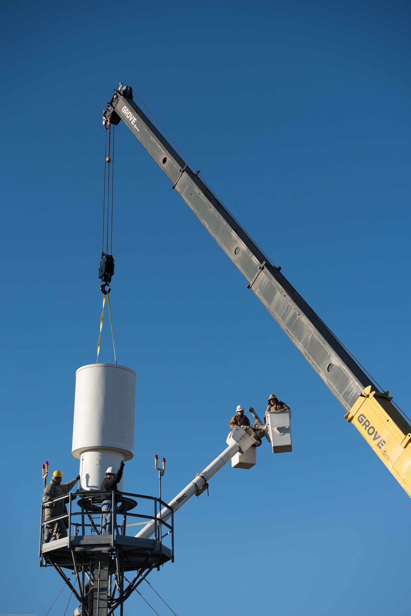 Airmen and contractors guide Offutt Air Force Base’s (AFB) legacy Tactical Air Navigation System (TACAN) as a crane operator hoists the system off its tower at Offutt AFB, Nebraska, Nov. 29, 2017.