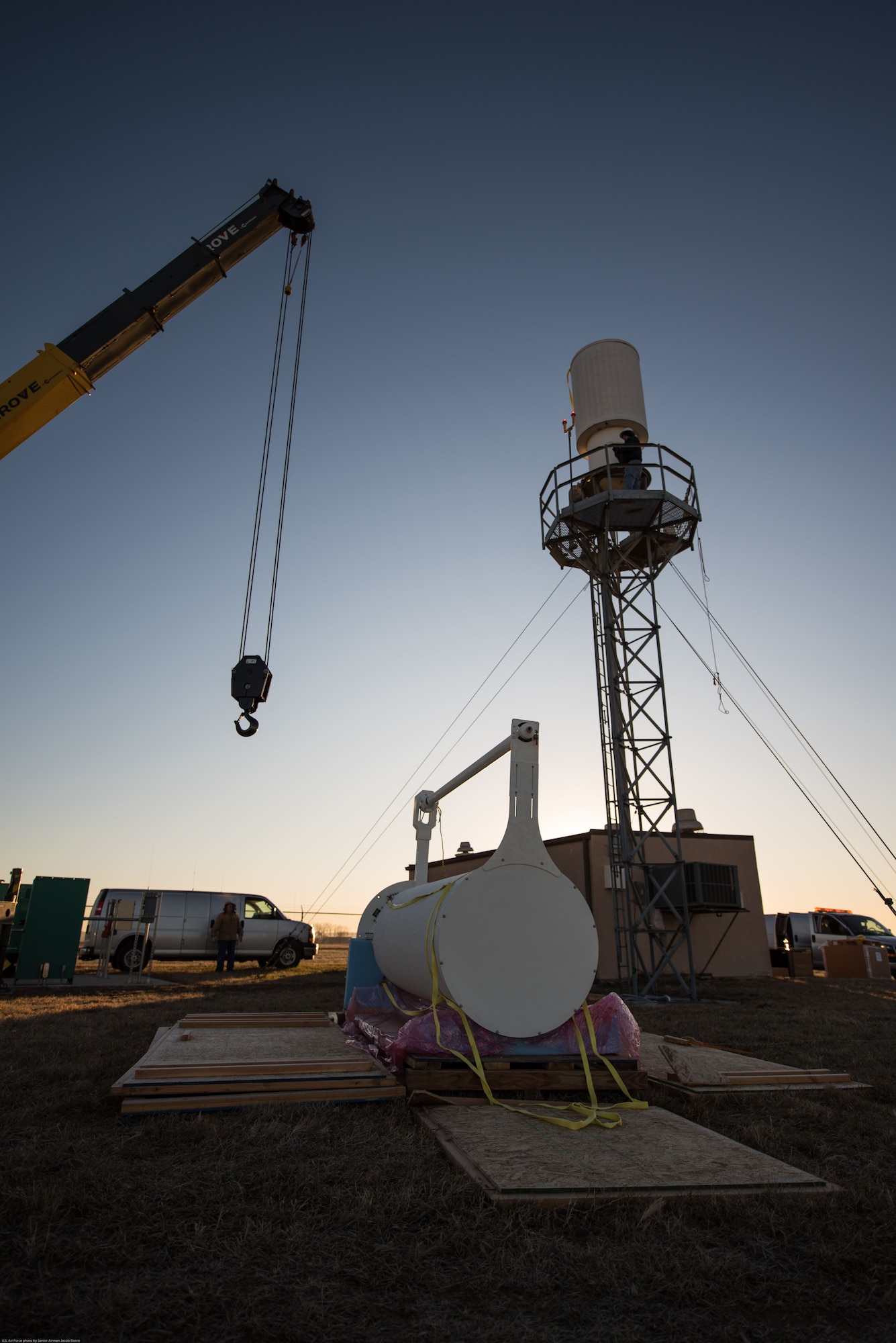 Airmen and contractors prepare to remove a legacy Tactical Air Navigation System from its tower and replace it with a modern version at Offutt Air Force Base, Nebraska, Nov. 29, 2017.