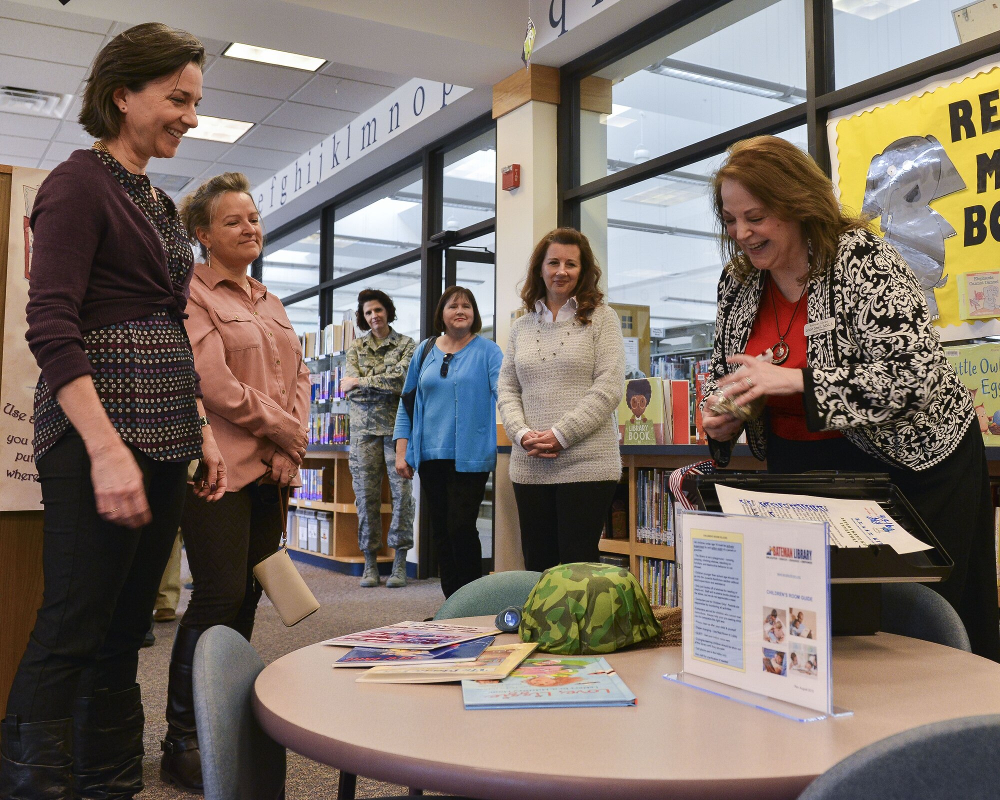 Sara Holmes, wife of U.S. Air Force Gen. Mike Holmes, commander of Air Combat Command (left) is shown an example of a book kit on Joint Base Langley-Eustis, Va., Dec. 1, 2017.