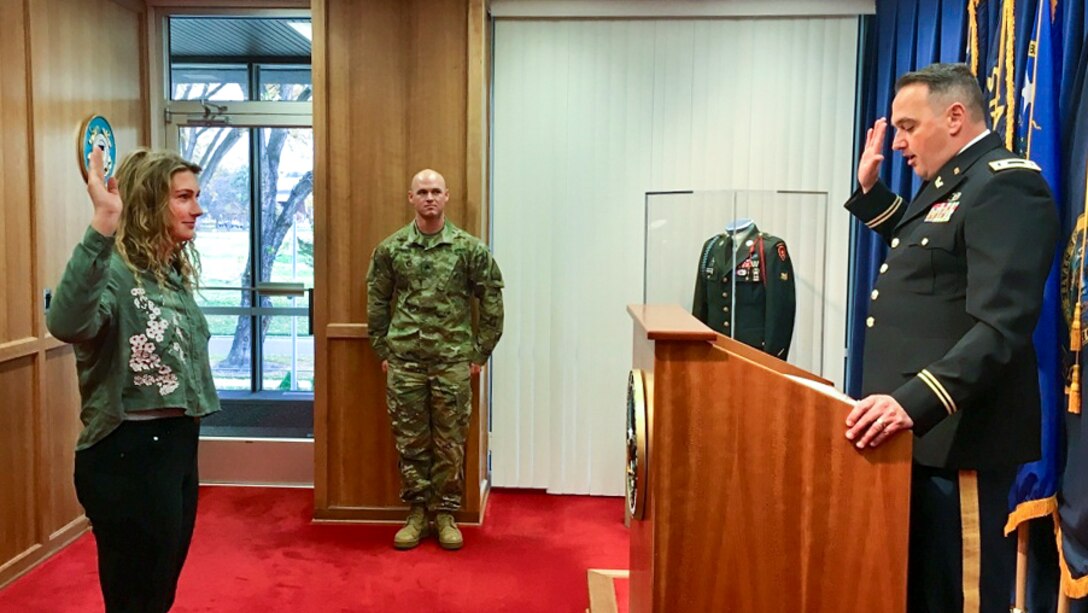 A soldier swears his daughter into the National Guard.