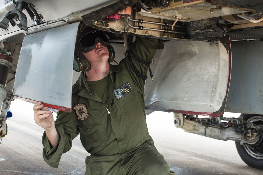 Cpl. William Thomason, a fixed-wing aircraft mechanic with Marine All-Weather Fighter Attack Squadron [VMFA(AW)] 225, conducts maintenance on an F/A-18D Hornet to support missions for Exercise Winter Fury 18 at Marine Corps Air Station Miramar, Calif., Nov. 30.  Winter Fury provides an opportunity for 3rd Marine Aircraft Wing to exercise the skills needed as the aviation combat element of a Marine Air-Ground Task Force during a combat deployment. (U.S. Marine Corps photo by Lance Cpl. Nadia J. Stark/Released)