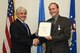 Eberhard Bauer, right, 72nd Air Base Wing Plans and Program Office management analyst is recognized for 20 years of civilian service along with a Civilian Personnel Achievement Award for his contributions on the Civilian Mentoring Council from Robert Sandlin, 72nd ABW director of staff, Nov. 28, 2017, Tinker Air Force Base, Oklahoma. The ceremony took place at the 72nd ABW Headquarters building.