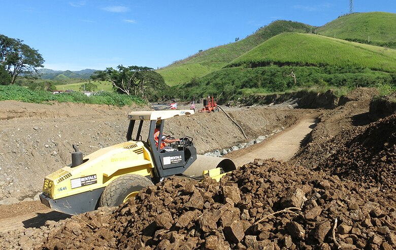 A vibratory soil compactor helps prepare the base of a new levee being constructed in Yauco, Puerto Rico, following Hurricane Maria floods that destroyed the previous one.