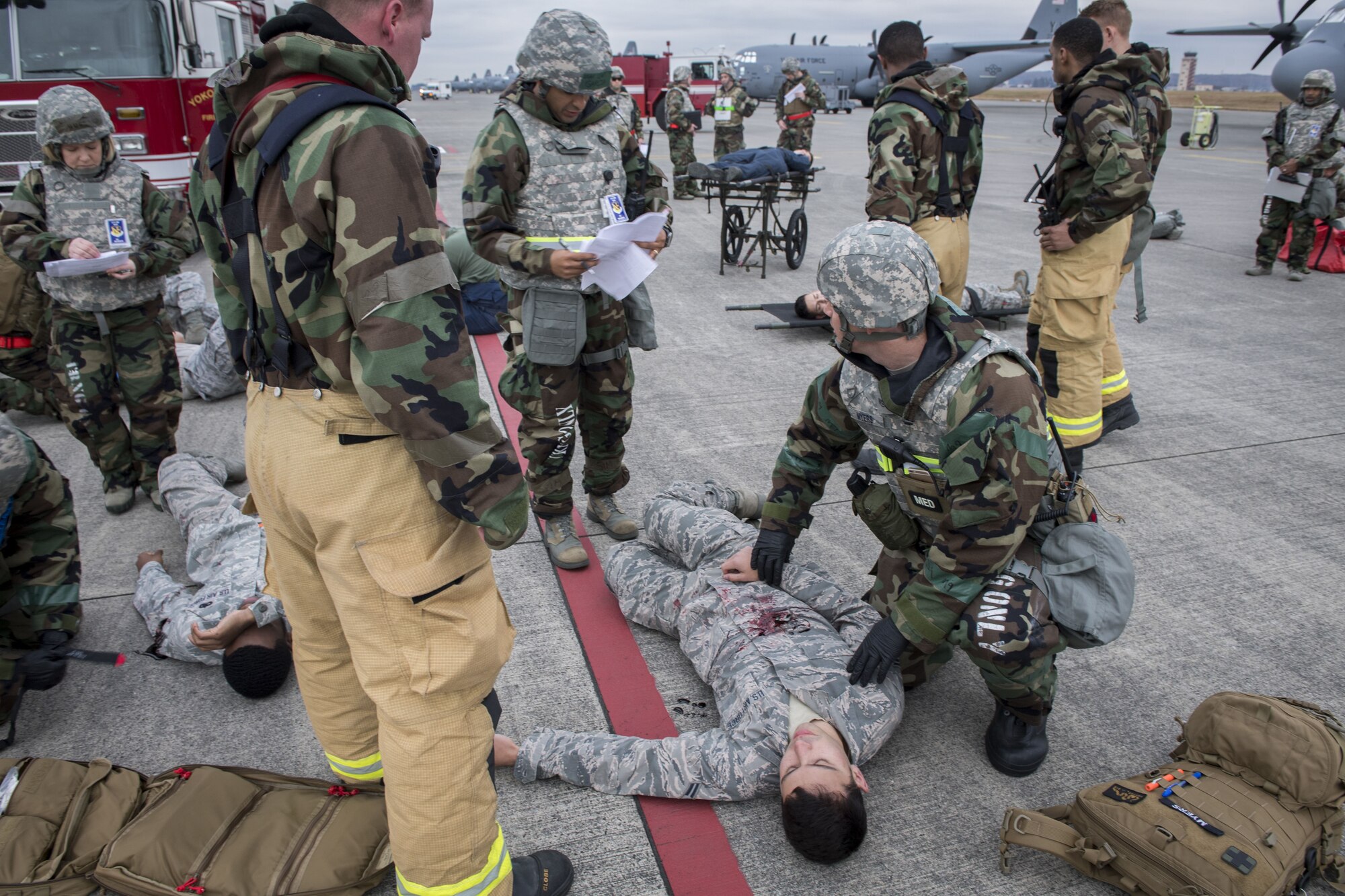 A 374th Medical Squadron medic evaluates a simulated missile attack victim during exercise Beverly Morning 17-08 in conjunction with exercise Vigilant Ace 18, Dec. 4, 2017, at Yokota Air Base, Japan.