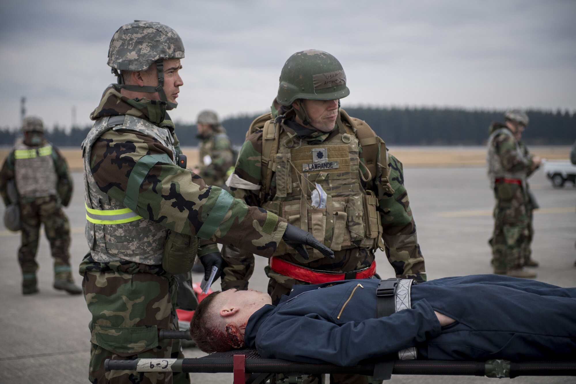 A 374th Medical Squadron medic explains the condition of a simulated victim to an on scene doctor during exercise Beverly Morning 17-08 in conjunction with exercise Vigilant Ace 18, Dec. 4, 2017, at Yokota Air Base, Japan.