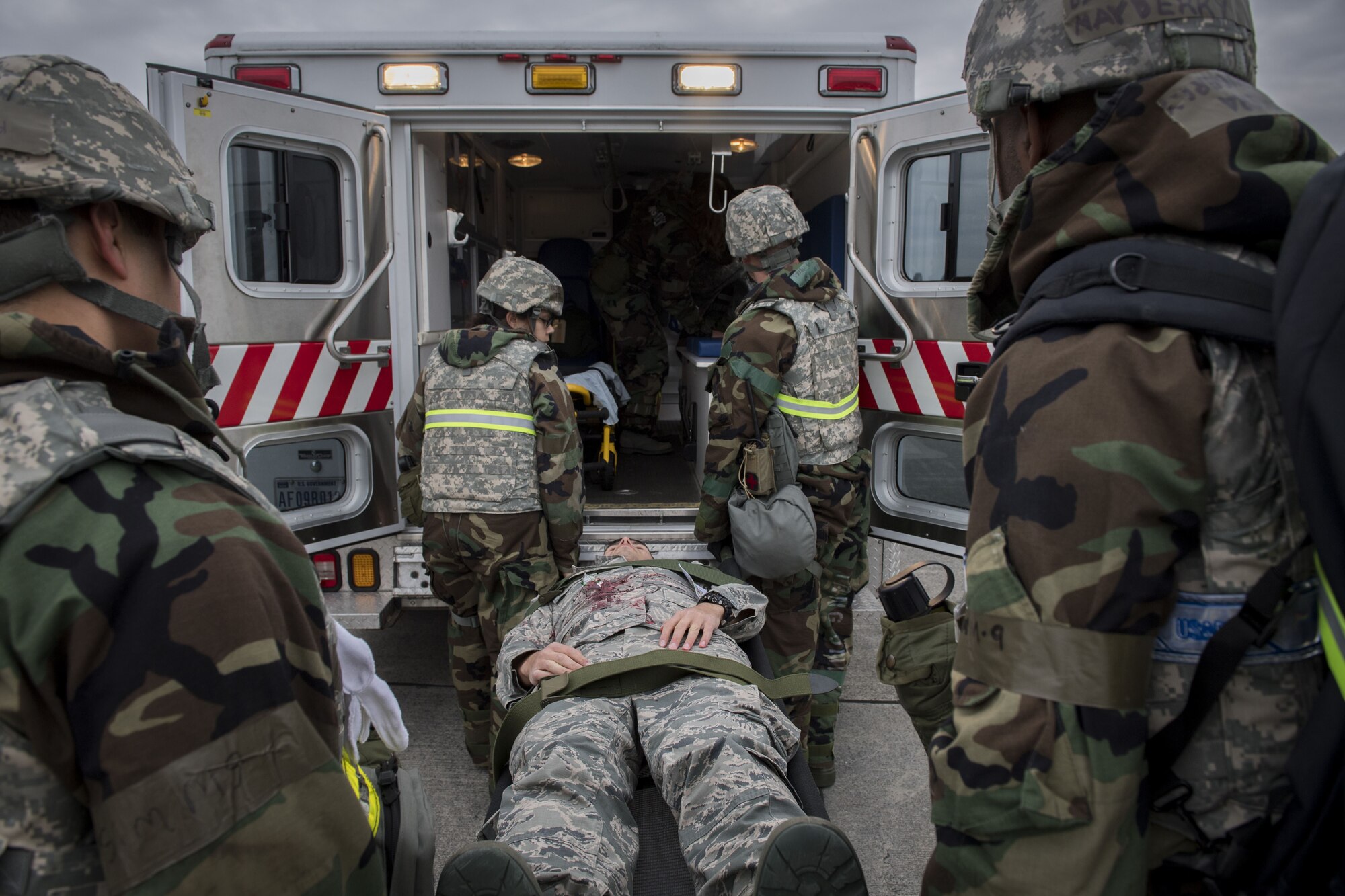 Emergency response crews from the 374th Medical Squadron place a simulated victim in an ambulance during exercise Beverly Morning 17-08 in conjunction with exercise Vigilant Ace 18, Dec. 4, 2017, at Yokota Air Base, Japan.