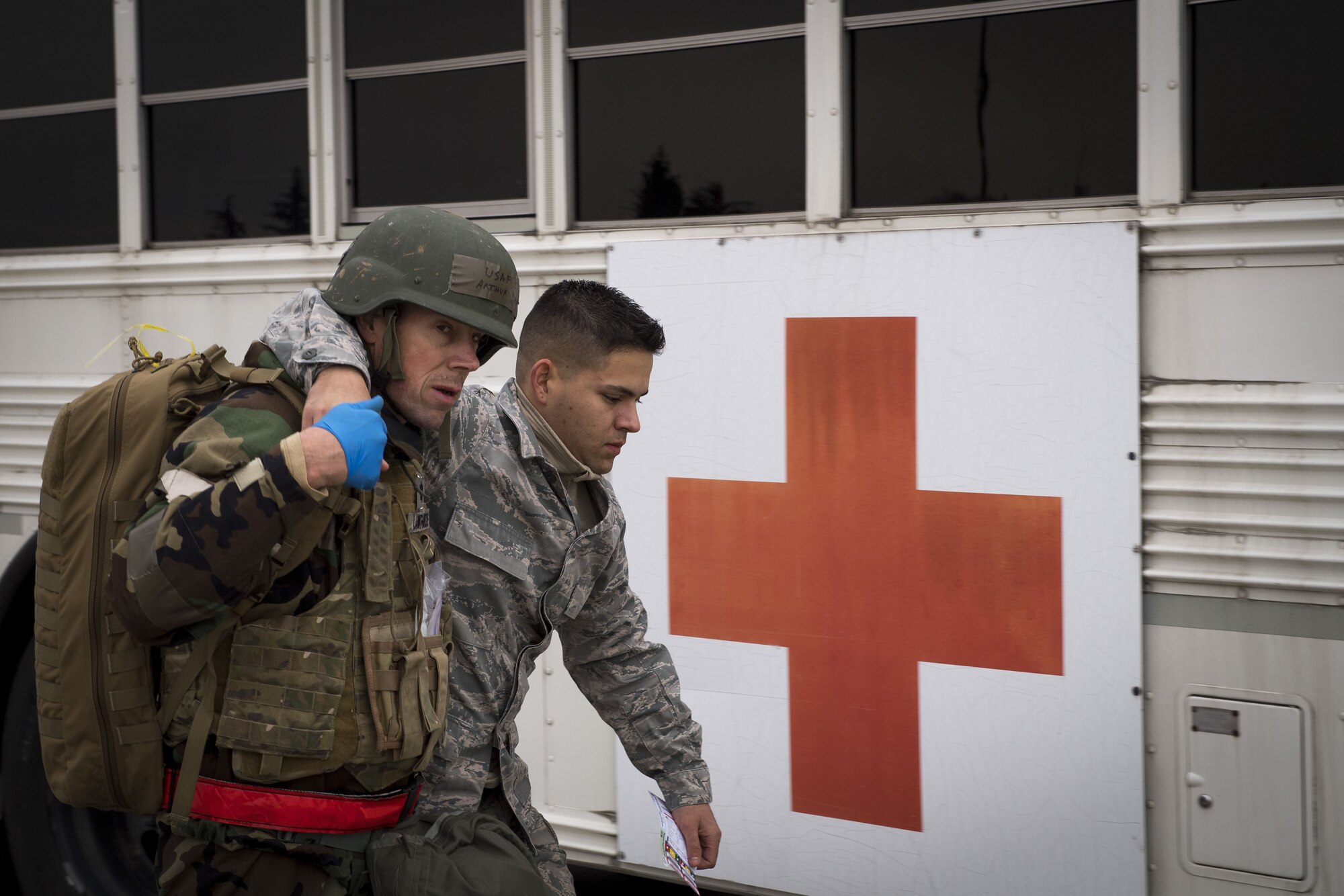A simulated victim is carried to medical transportation by a 374th Medical Squadron on scene doctor during exercise Beverly Morning 17-08 in conjunction with exercise Vigilant Ace 18, Dec. 4, 2017, at Yokota Air Base, Japan.