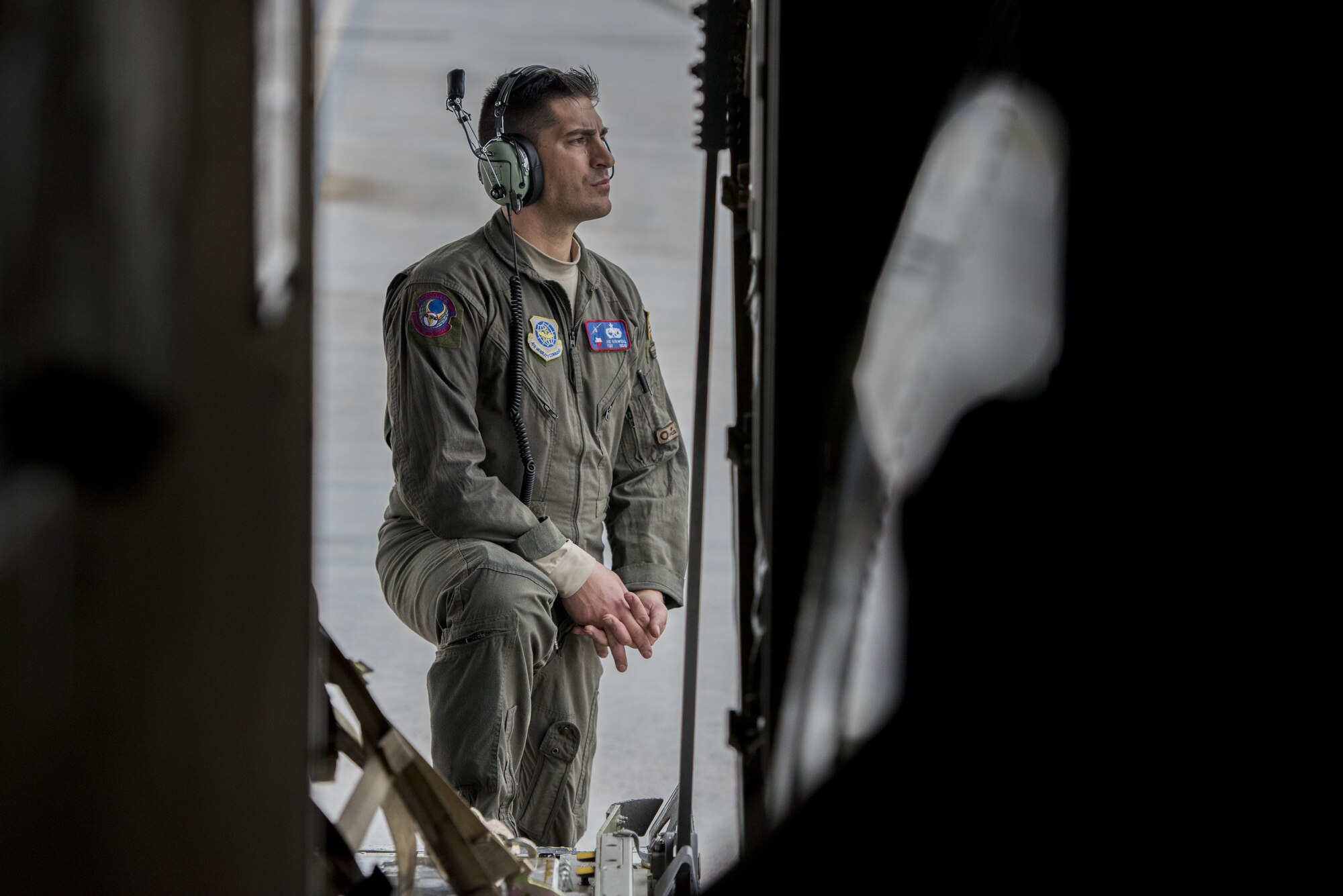 Tech Sgt. Joe Colwell, 40th Airlift Squadron C-130J Super Hercules flying crew chief, waits to take off, Dec. 1, 2017, at Kadena Air Base, Japan.