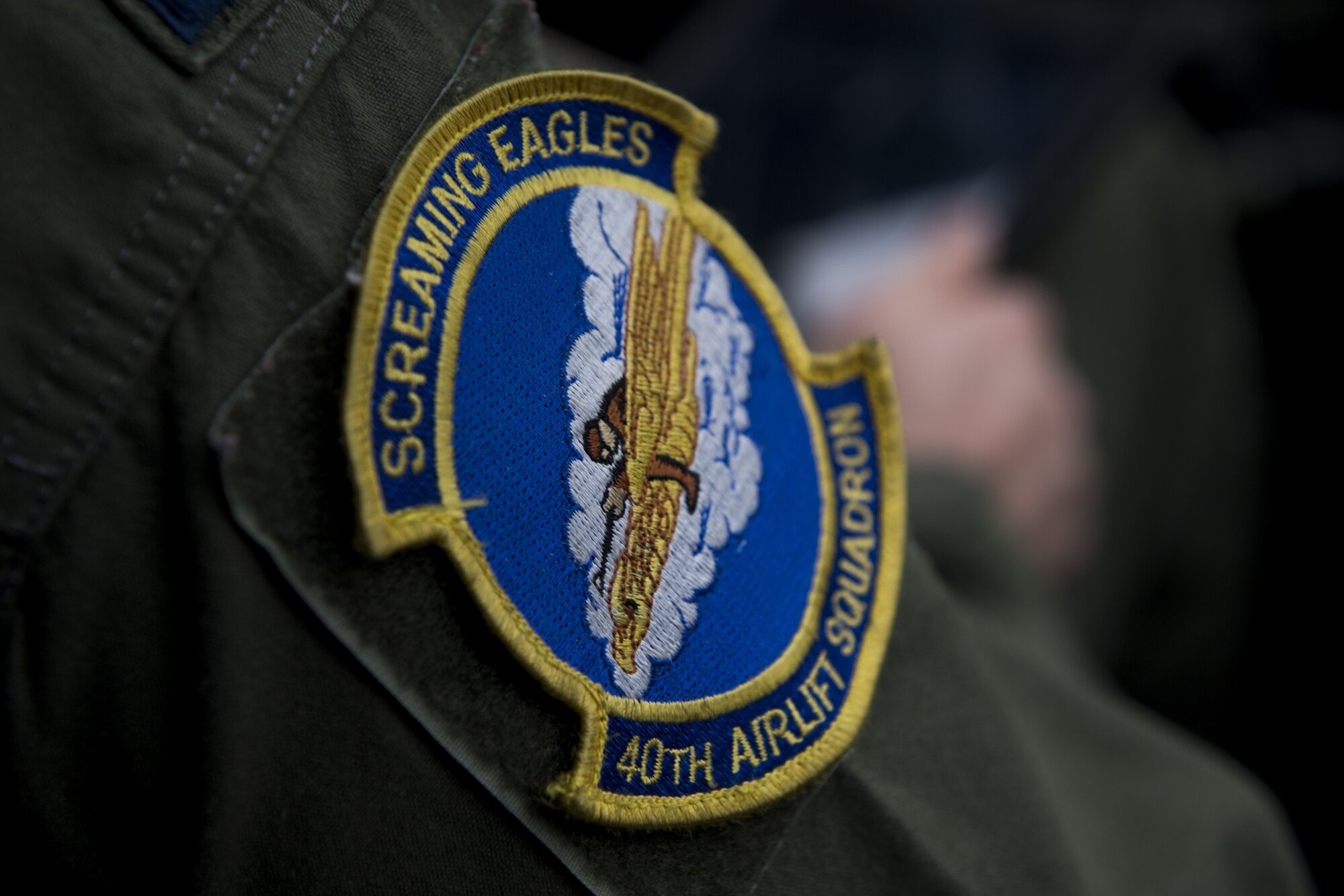 The Screaming Eagles 40th Airlift Squadron patch rests on the arm of Capt. Kyle Schneider, 40 AS C-130J Super Hercules pilot, Dec, 1, 2017, at Yokota Air Base, Japan.