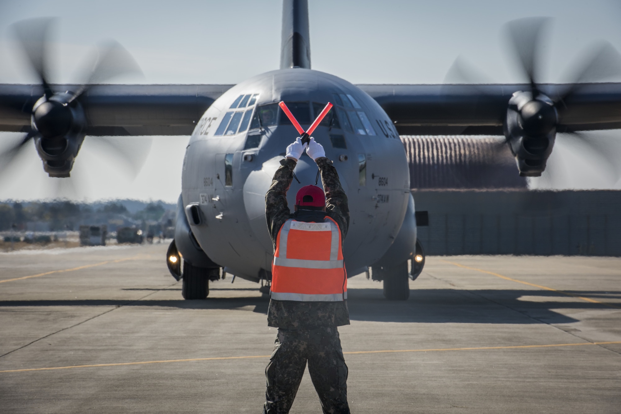 An Airman with the Republic of Korea Air Force signals to a U.S. Air Force C-130J Super Hercules where to stop in preparation for exercise Vigilant Ace 18, Dec. 1, 2017, at Gwangju Airbase, Republic of Korea.