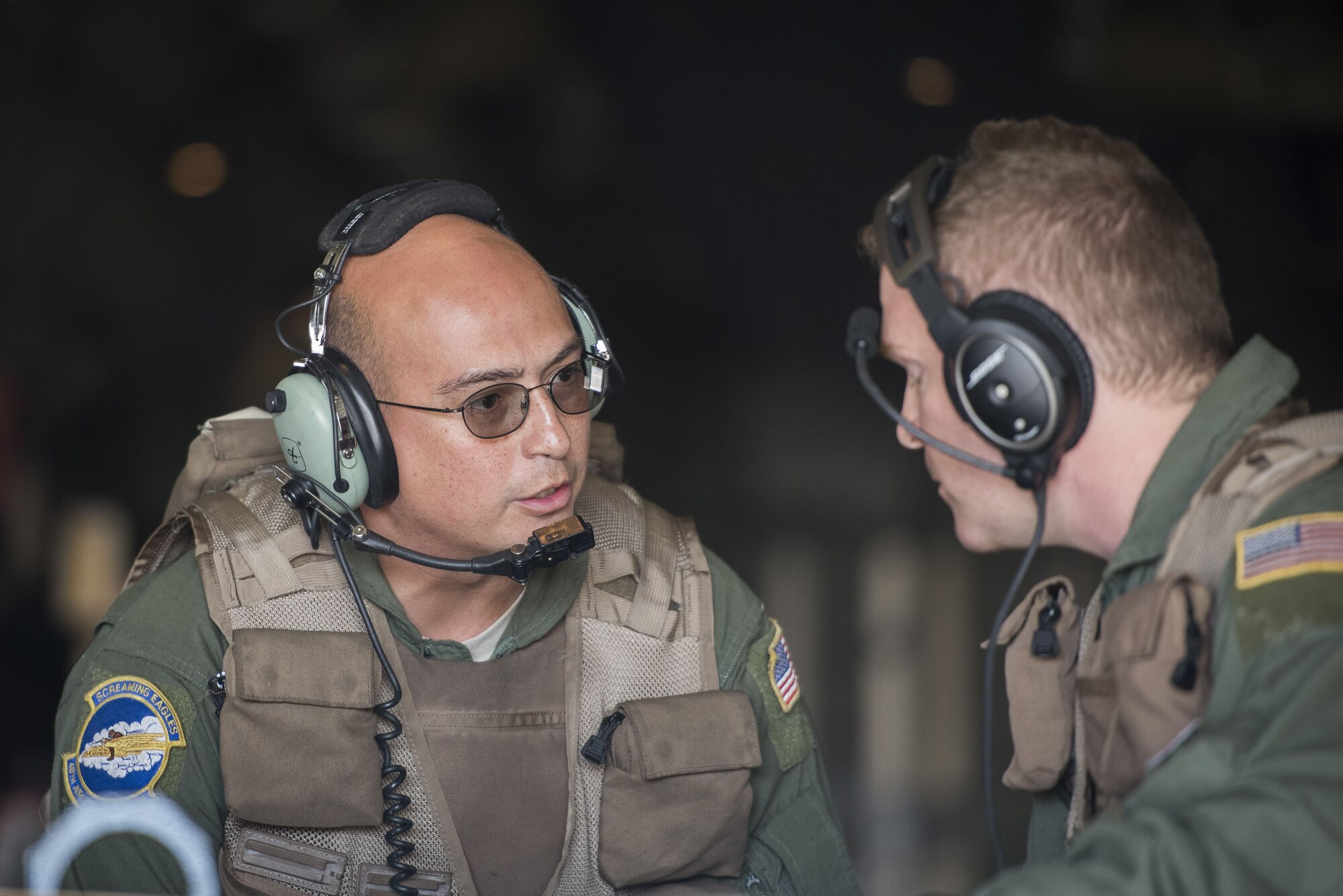 Tech Sgt. Gary Woolridge, 40th Airlift Squadron C-130J Super Hercules loadmaster, talks to Staff Sgt. Craig Morrison, 40 AS C-130J loadmaster, while unloading cargo in preparation for exercise Vigilant Ace 18, Dec. 1, 2017, at Gwangju Airbase, Republic of Korea.
