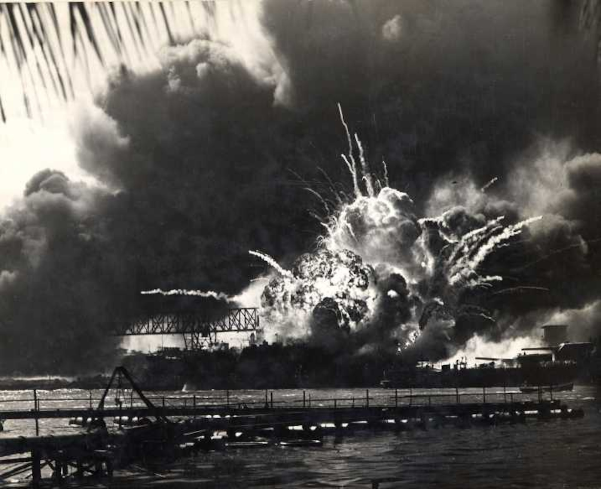 This photo, provided by the Robins Air Force Base History Office shows the USS Arizona coming under attack at Pearl Harbor. (Robins History Office Photo)