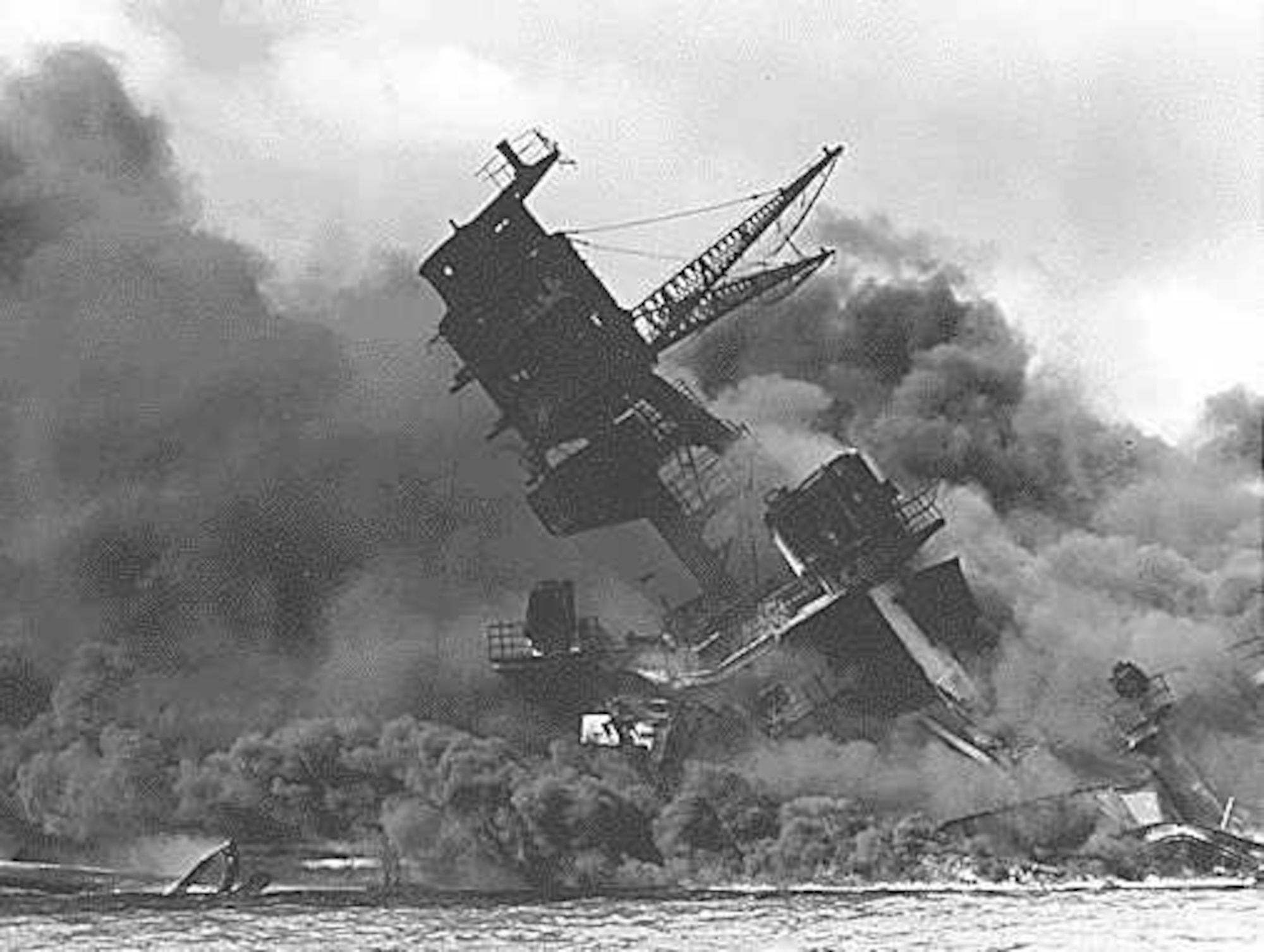 This photo, provided by the Robins Air Force Base History Office shows the USS Arizona coming under attack at Pearl Harbor. (Robins History Office Photo)