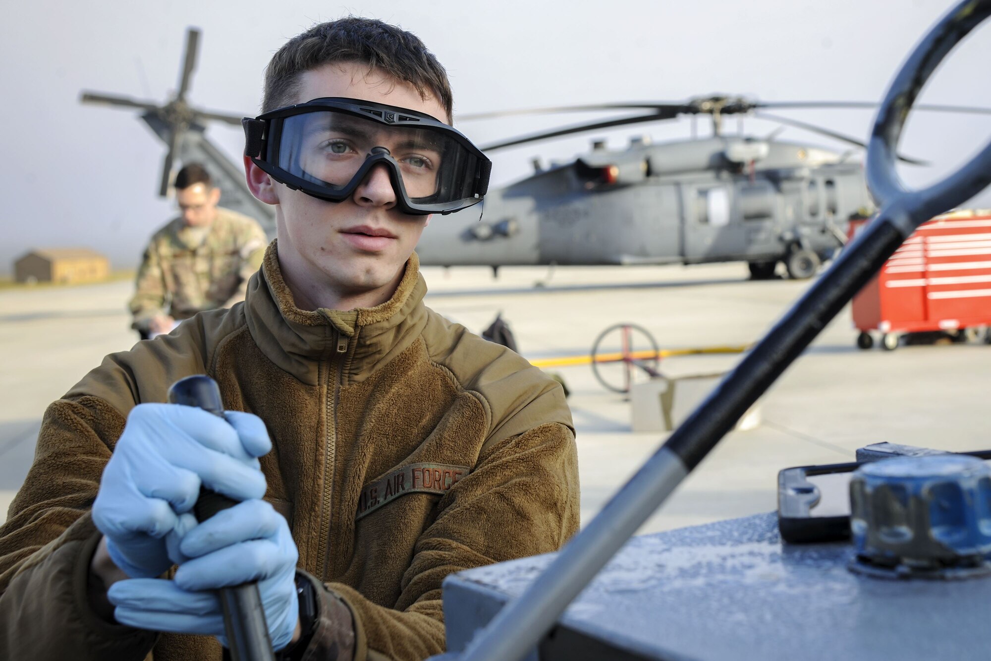Senior Airman Nicholas Dacyk, 723d Aircraft Maintenance Squadron hydraulics systems apprentice, pulls a lever attached to an HH-60G Pave Hawk, Dec. 5, 2017, at Moody Air Force Base, Ga. As part of a Phase 1, Phase 2 exercise, the 23d Wing is evaluating its operations, maintenance and logistics to determine its readiness to rapidly deploy. Airmen from the 723d Aircraft Maintenance Squadron folded the main and tail rotor blades inward to make it easier to transport and then unfolded the rotors to practice making the helicopter operational. (U.S. Air Force photo by Airman Eugene Oliver)