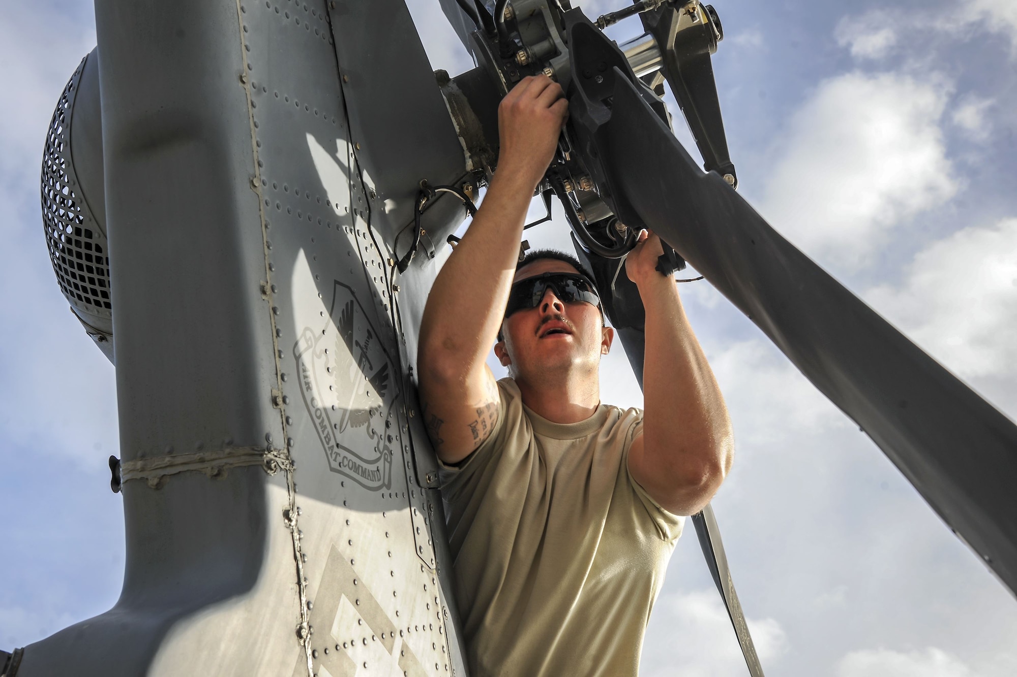 Senior Airman Trevor Krutsch, 723d Aircraft Maintenance Squadron hydraulics systems apprentice, unfolds the rotor of an HH-60G Pave Hawk, Dec. 5, 2017, at Moody Air Force Base, Ga. As part of a Phase 1, Phase 2 exercise, the 23d Wing is evaluating its operations, maintenance and logistics to determine its readiness to rapidly deploy. Airmen from the 723d Aircraft Maintenance Squadron folded the main and tail rotor blades inward to make it easier to transport and then unfolded the rotors to practice making the helicopter operational. (U.S. Air Force photo by Airman Eugene Oliver)