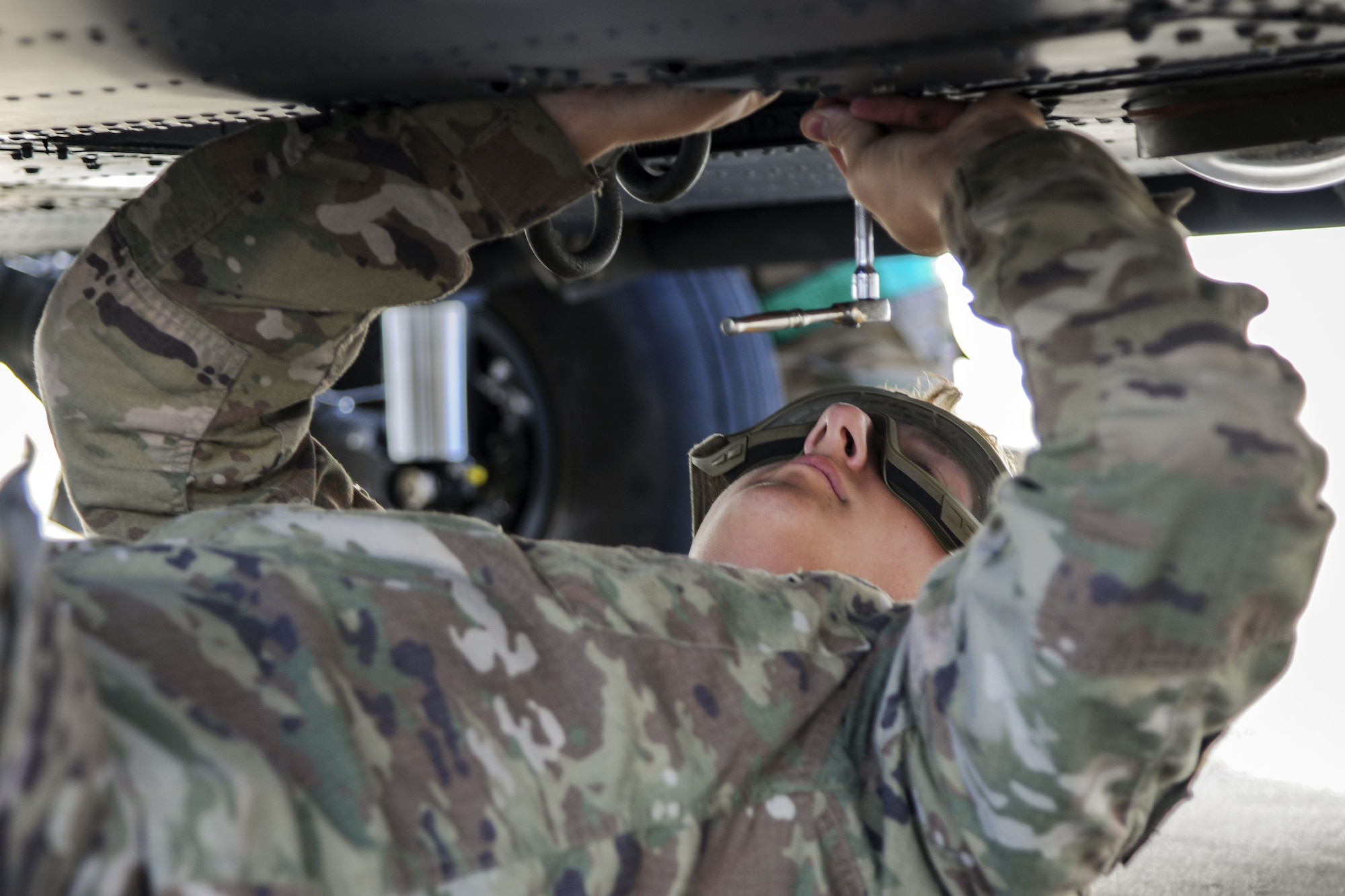 Senior Airman Greggory Petkewicz, 723d Aircraft Maintenance Squadron crew chief, tightens a screw on a HH-60G Pave Hawk, Dec. 5, 2017, at Moody Air Force Base, Ga. As part of a Phase 1, Phase 2 exercise, the 23d Wing is evaluating its operations, maintenance and logistics to determine its readiness to rapidly deploy. Airmen from the 723d Aircraft Maintenance Squadron folded the main and tail rotor blades inward to make it easier to transport and then unfolded the rotors to practice making the helicopter operational.  (U.S. Air Force photo by Airman Eugene Oliver)