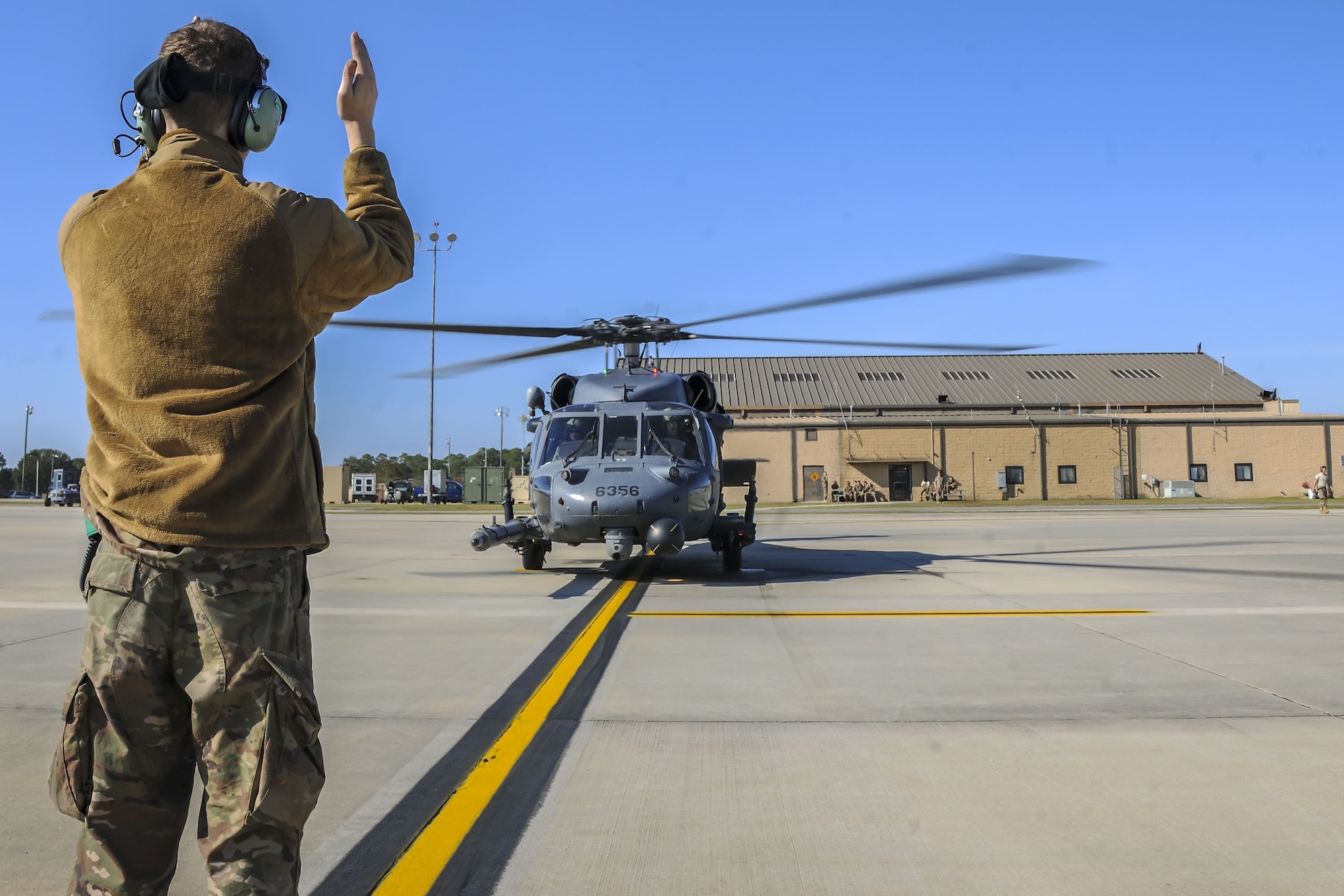 Senior Airman Nicholas Dacyk, 723d Aircraft Maintenance Squadron hydraulics systems apprentice, marshals an HH-60G Pave Hawk, Dec. 5, 2017, at Moody Air Force Base, Ga. As part of a Phase 1, Phase 2 exercise, the 23d Wing is evaluating its operations, maintenance and logistics to determine its readiness to rapidly deploy. The HH-60 capabilities were tested to determine the 723d Aircraft Maintenance Squadron’s ability to make a helicopter operational. (U.S. Air Force photo by Airman Eugene Oliver)
