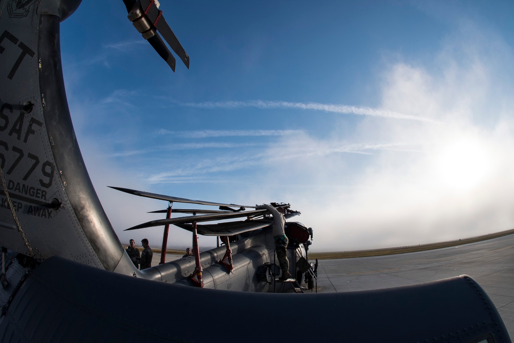 Airmen from the 723d Aircraft Maintenance Squadron begin unfolding an HH-60G Pave Hawk during an exercise, Dec. 5, 2017, at Moody Air Force Base, Ga. Moody’s Phase 1, Phase 2 exercise tested the 23d Wing’s ability to prepare, deploy and execute their mission at a moment’s notice. The 723d AMXS was tasked with folding HH-60s in preparation for transport in a larger aircraft and unfolding them once they arrive at their final destination. During folding, the rotor blades are revolved and aligned with the body of the helicopter, and fastened into place. (U.S. Air Force photo by Senior Airman Janiqua P. Robinson)