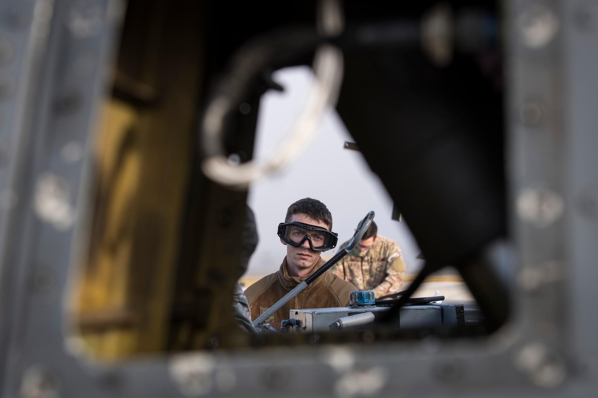 Senior Airman Nicholas Dacyk, 723d Aircraft Maintenance Squadron hydraulics systems apprentice, drains hydraulic fluid from an HH-60G Pave Hawk during an exercise, Dec. 5, 2017, at Moody Air Force Base, Ga. Moody’s Phase 1, Phase 2 exercise tested the 23d Wing’s ability to prepare, deploy and execute their mission at a moment’s notice. The 723d AMXS was tasked with folding HH-60s in preparation for transport in a larger aircraft and unfolding them once they arrive at their final destination. During folding, the rotor blades are revolved and aligned with the body of the helicopter, and fastened into place. (U.S. Air Force photo by Senior Airman Janiqua P. Robinson)