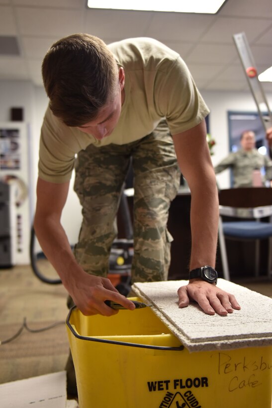 Senior Airman Adam Kresge, structural engineering journeyman with the 911th Civil Engineering Squadron, cuts a piece of ceiling tile at the Pittsburgh International Airport Air Reserve Station, Dec. 3, 2017. Airmen of the 911th CES propel the 911th Airlift Wing's mission by serving as the structural backbone of all buildings on the base. (U.S. Air Force photo by Staff Sgt. Marjorie A. Bowlden)