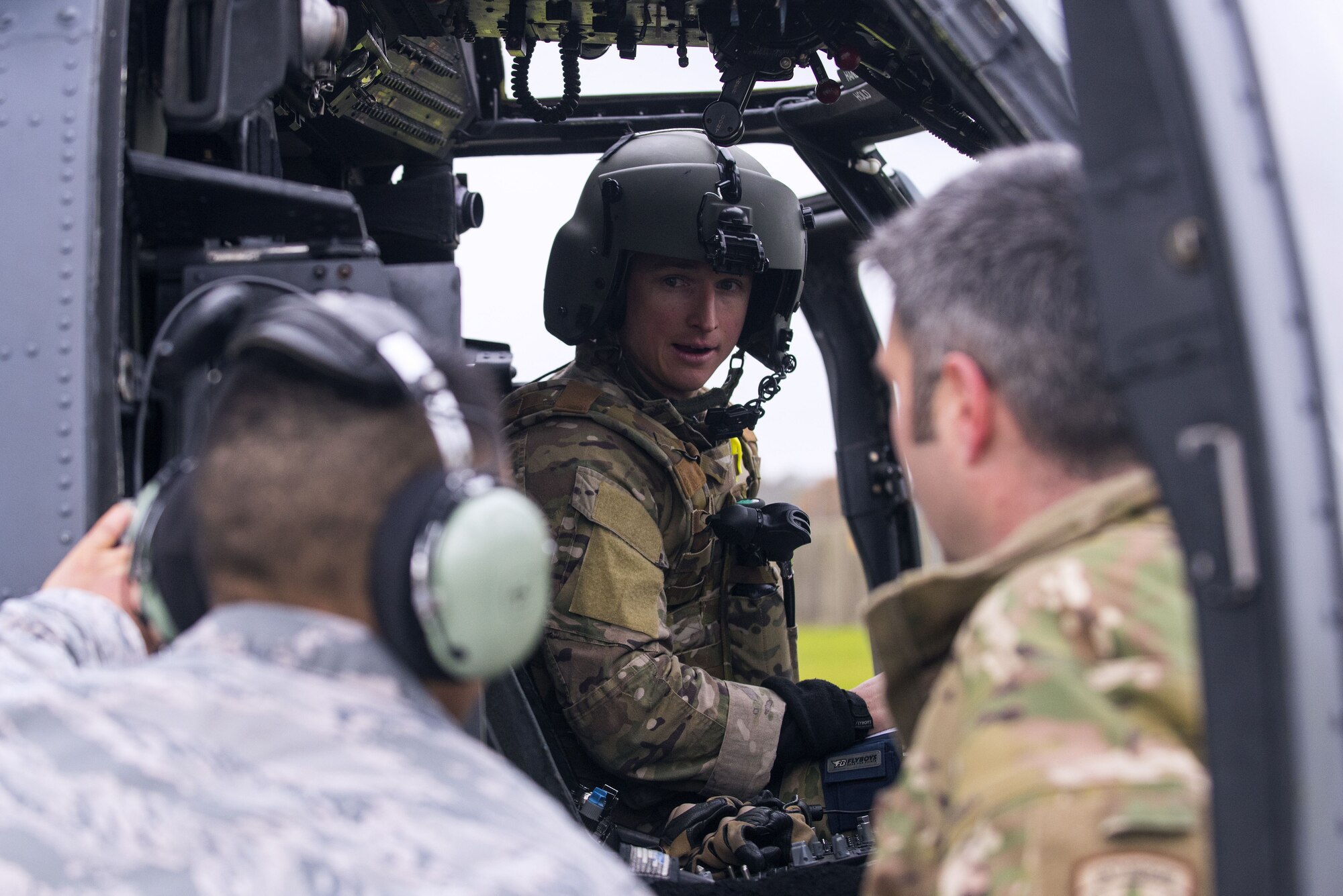 An HH-60G Pave Hawk pilot from the 56th Rescue Squadron talks to special mission aviators during post-flight inspections at Royal Air Force Lakenheath, England, Nov. 19, 2017. With more than 20 years of service, the Pave Hawk has been an essential tool for pararescue units worldwide. (U.S. Air Force photo/Senior Airman Malcolm Mayfield)