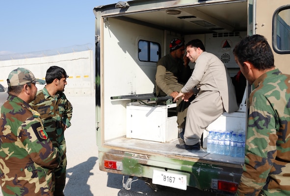 Members of the Afghan National Army transport family members and two recovering children back to their home.