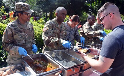Brooke Army Medical Center deputy commanding officer Col. Traci Crawford and Command Sgt. Maj. Diamond Hough serve a Thanksgiving-style feast to Warrior Transition Battalion Soldiers and their families Nov. 17 at the Warrior and Family Support Center at Joint Base San Antonio-Fort Sam Houston.