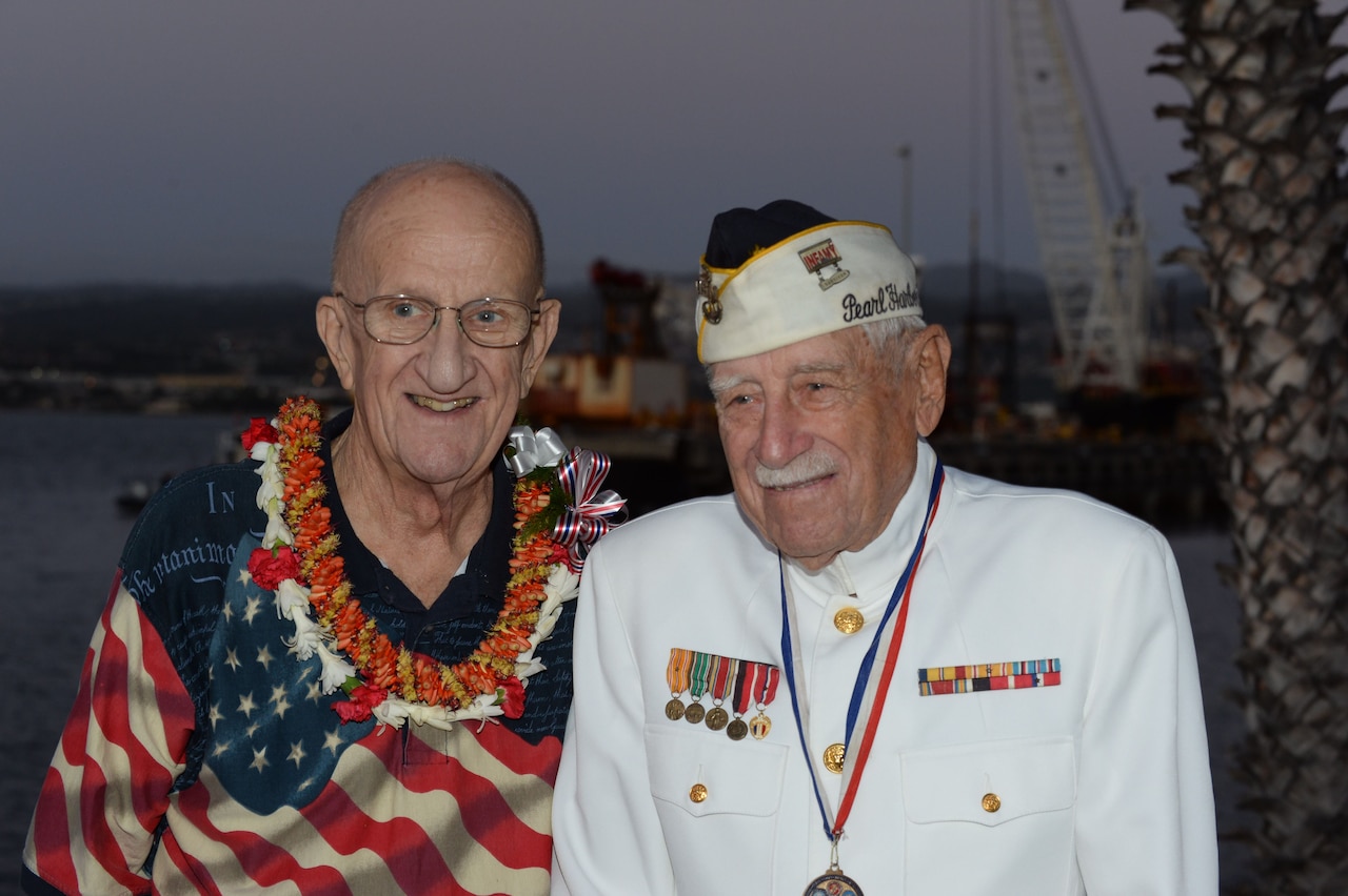 Jim Taylor, the Pearl Harbor survivor liaison for Commander, Navy Region Hawaii, left, poses for a photo with Gil "Wally" Meyer, a Pearl Harbor survivor, during a double interment ceremony at the USS Utah Memorial in Pearl Harbor, Hawaii.