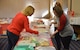 Members of the Kirtland Spouses' Club organize cookie plates during the 2016 cookie drive. The KSC will run its annual drive Dec. 10-11 and hopes to best last year's donations, which reached more than 12,000 cookies donated from the base community.