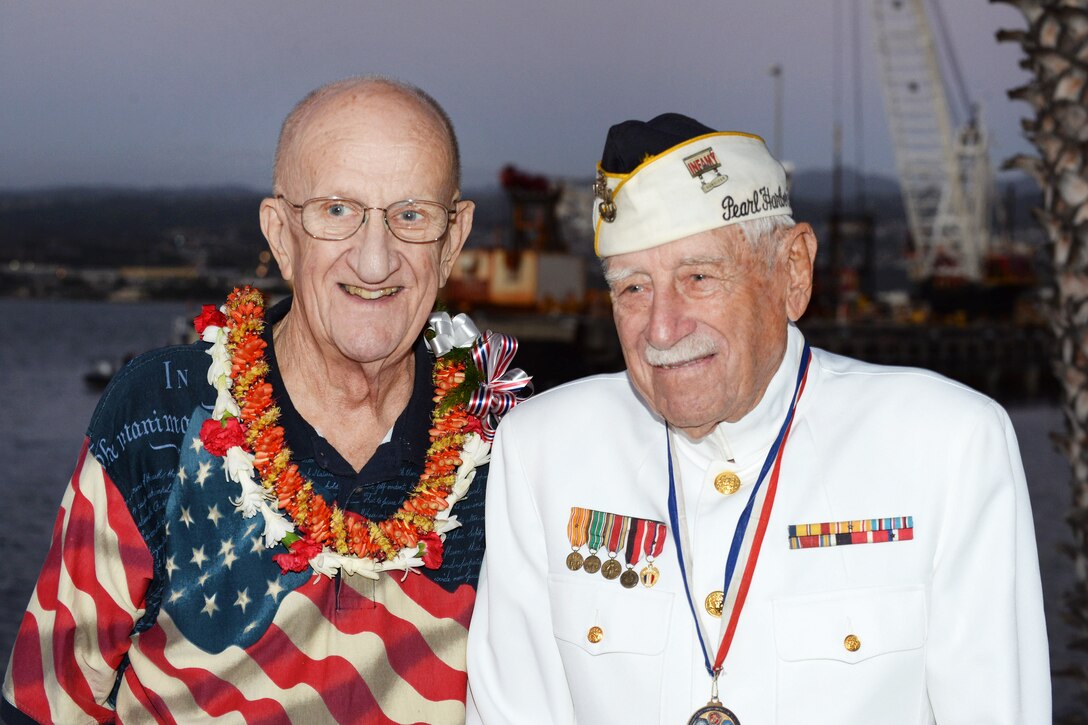 Jim Taylor, the Pearl Harbor survivor liaison for Commander, Navy Region Hawaii, left, poses for a photograph with Gil "Wally" Meyer, a Pearl Harbor survivor.