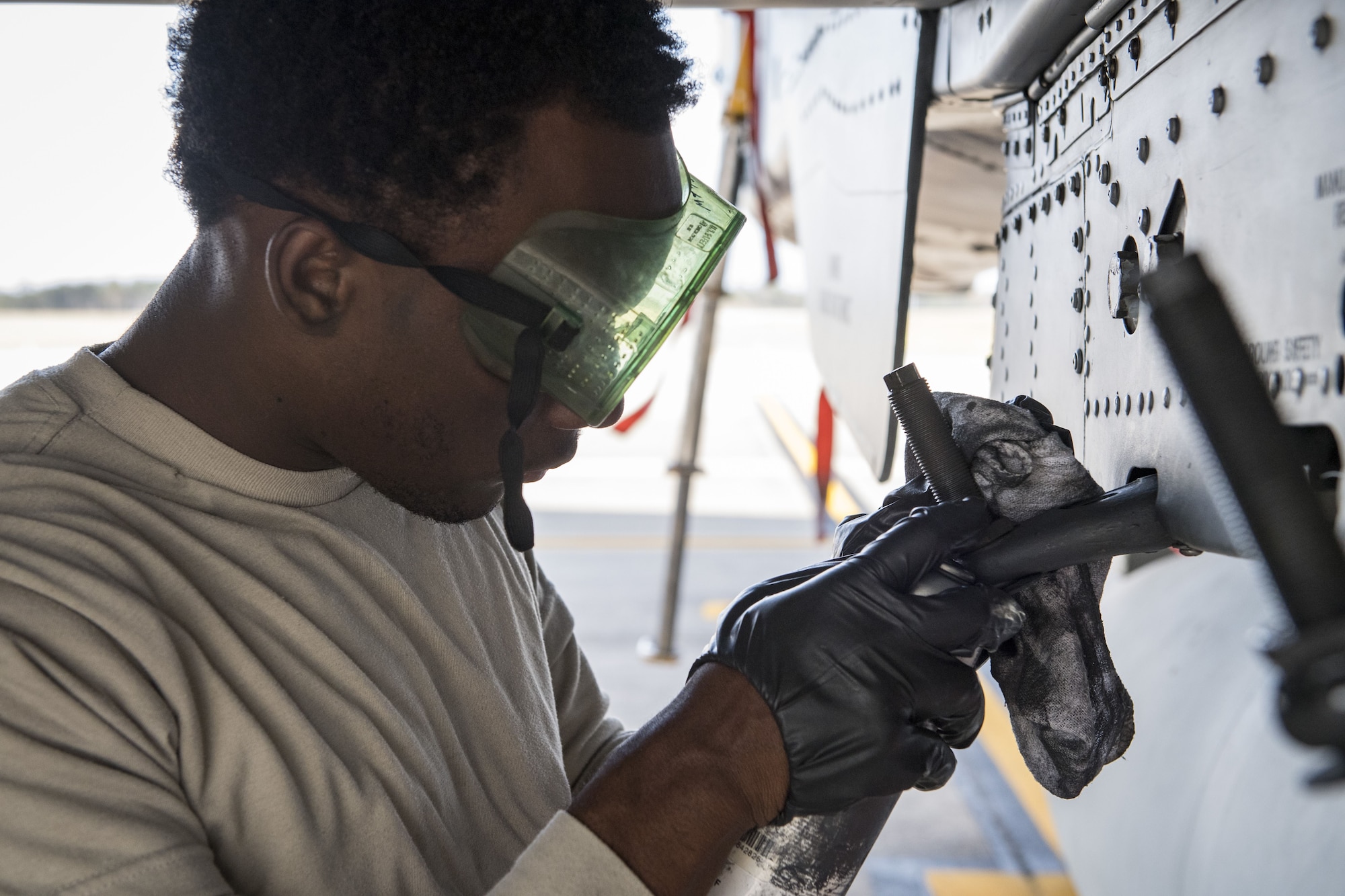 Airman 1st Class Manuel Scott, 23d Aircraft Maintenance Squadron armament specialist, spray paints fixtures on an A-10C Thunderbolt II during an exercise, Dec. 5, 2017, at Moody Air Force Base, Ga. During Moody’s Phase 1, Phase 2 exercise, leadership tested Airmen across maintenance units on their abilities to accurately and efficiently ready aircraft and cargo to deploy. The exercise tasked Airmen from various aircraft maintenance units (AMU) to generate 16 aircraft from Moody’s fleet of A-10C Thunderbolt II’s. (U.S. Air Force photo by Senior Airman Janiqua P. Robinson)