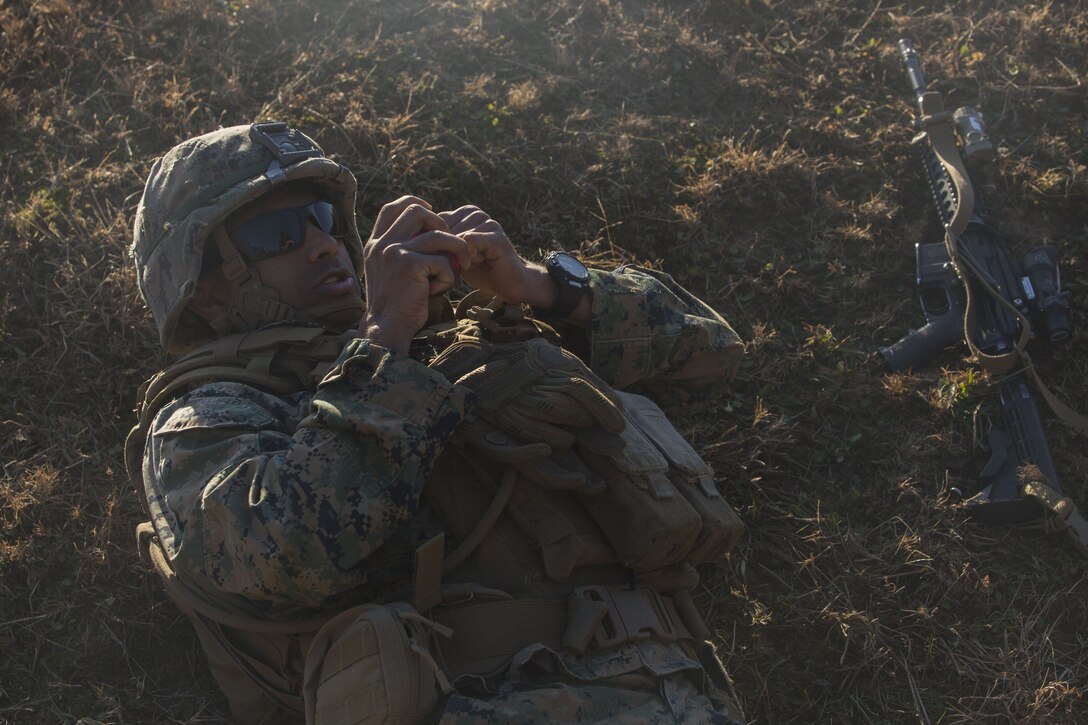 PFC Mohammad Ansari, a Marine with 2nd Battalion, 8th Marine Regiment, prepares an M69 training grenade at a grenade range during a deployment for training exercise at Fort A.P. Hill, V.A., Dec. 1, 2017. The range consisted of the Marines reacting to enemy contact, buddy rushing, using M69 training grenades and M67 fragmentation grenades. The Marines are conducting the DFT to maintain proficiency at the squad, platoon, company, and battalion-level of warfighting in preparation for an upcoming deployment to Japan. (U.S. Marine Corps photo by Lance Cpl. Ashley McLaughlin)