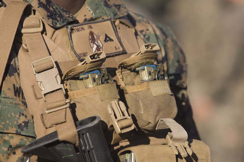 A Marine with 2nd Battalion, 8th Marine Regiment carries M69 training grenades loaded in his grenade pouches at a grenade range during a deployment for training exercise at Fort A.P. Hill, V.A., Dec. 1, 2017. The range consisted of the Marines reacting to enemy contact, buddy rushing, using M69 training grenades and M67 fragmentation grenades. The Marines are conducting the DFT to maintain proficiency at the squad, platoon, company, and battalion-level of warfighting in preparation for an upcoming deployment to Japan. (U.S. Marine Corps photo by Lance Cpl. Ashley McLaughlin)