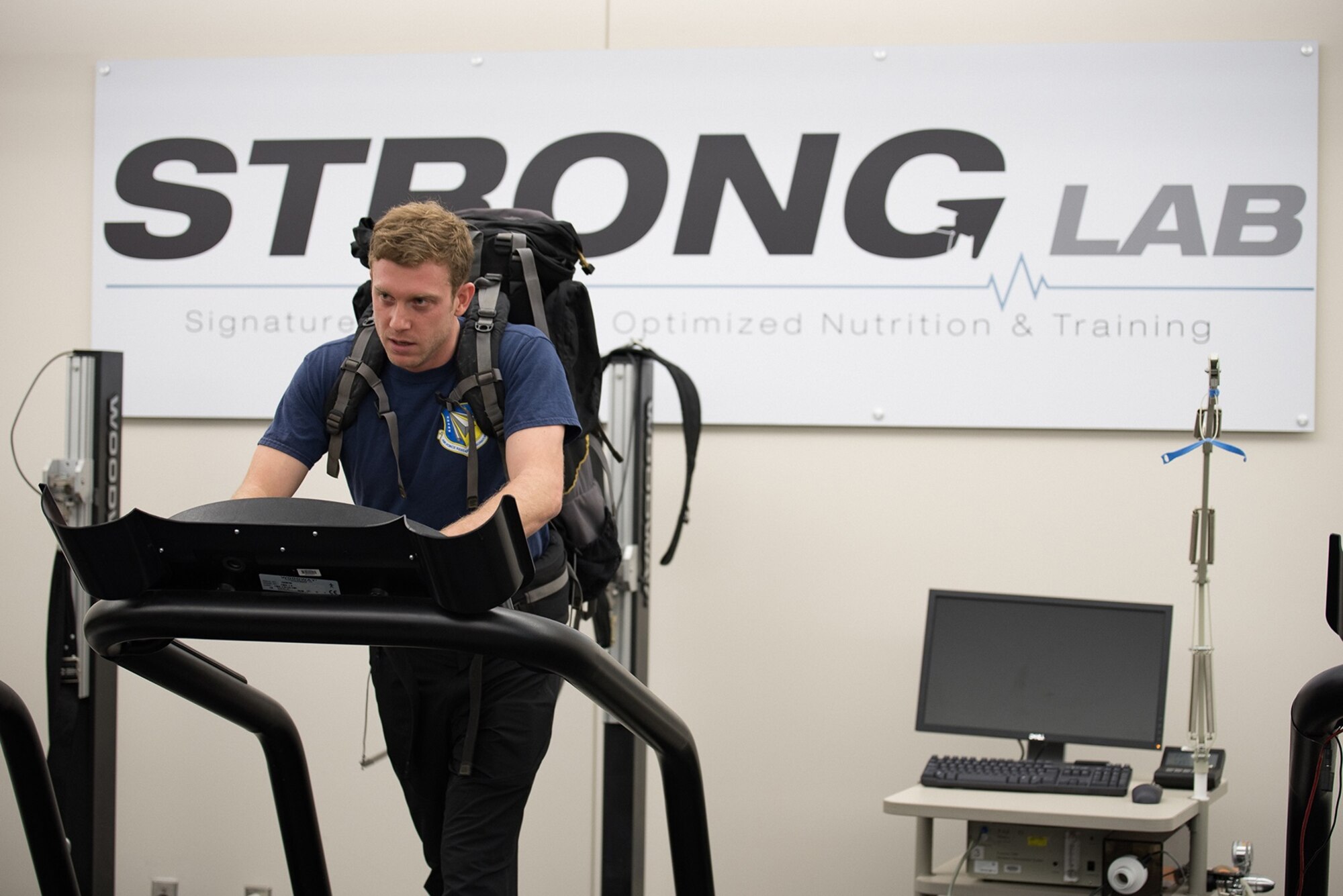 Kevin Schmidt, research engineering psychologist in the Air Force Research Laboratory and Defense Department Science, Mathematics and Research for Transformation (SMART) scholar at Northwestern University, walks on the treadmill with a 70-pound pack to demonstrate one of the ways he has been training for his climb of Mount Aconcagua in South America. He and his team seek to identify new ways to prepare warfighters for deployments in high altitude environments. (U.S. Air Force photo by Richard Eldridge/released)