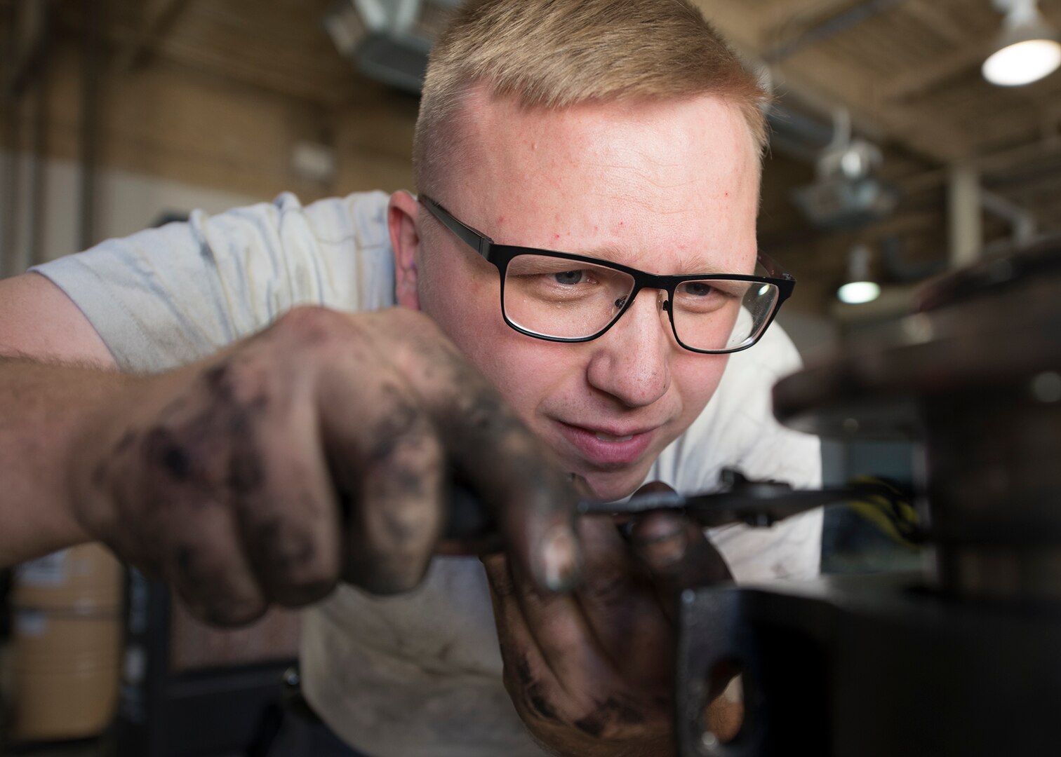 Senior Airman Johnathan Bailey, 49th Logistics Readiness Squadron mission generating vehicle and equipment maintenance journeyman, loosens a retaining ring before separating two vehicle parts that have been leaking fuel at Holloman Air Force Base, N.M., Dec. 4, 2017. The shop’s mission is to keep enough vehicles and pumps running to supply fuel to all the Aircraft on the flightline as well as equipment around base. (U.S. Air Force photo by Staff Sgt. Timothy M. Young)