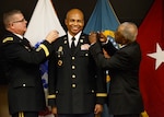 DLA Troop Support Commander Army Brig. Gen. Mark Simerly, left, places Army Col. James G. Gill’s, center, new colonel rank onto his uniform, along with Gill’s cousin Steve Peay during a promotion ceremony at DLA Troop Support in Philadelphia December 1, 2017. Gill is DLA Troop Support’s new Joint Reserves Forces team lead, joining the organization in November.