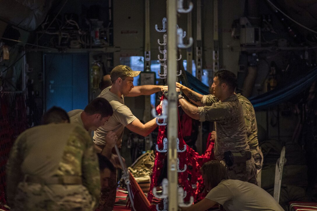 Airmen prepare the interior of a cargo aircraft before a mission.