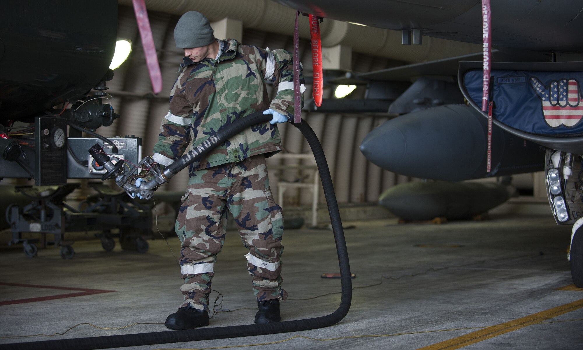 A U.S. Air Force Airman assigned to the 8th Fighter Wing, prepares to refuel an F-16 Fighting Falcon during exercise VIGILANT ACE 18 at Kunsan Air Base, Republic of Korea, Dec. 4, 2017.  The regularly scheduled flying exercise features more than 230 aircraft with U.S. and Republic of Korea Air Force personnel working alongside each other, comparable to participation from previous years’ iterations. (U.S. Air Force photo by Staff Sgt. Victoria H. Taylor)