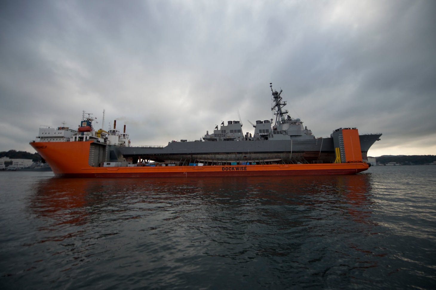 YOKOSUKA, Japan (Dec. 1, 2017) The Arleigh Burke-class guided-missile destroyer  USS Fitzgerald (DDG 62) departed Pier 9 at Fleet Activities (FLEACT) Yokosuka, Dec. 1, to proceed to anchorage in Yokosuka Harbor aboard heavy lift transport vessel MV Transshelf in order to make underway preparations. The Arleigh Burke-class guided-missile destroyer will soon be transported to Huntington Ingalls Industries in Pascagoula, Mississippi, for further repairs and upgrades.
