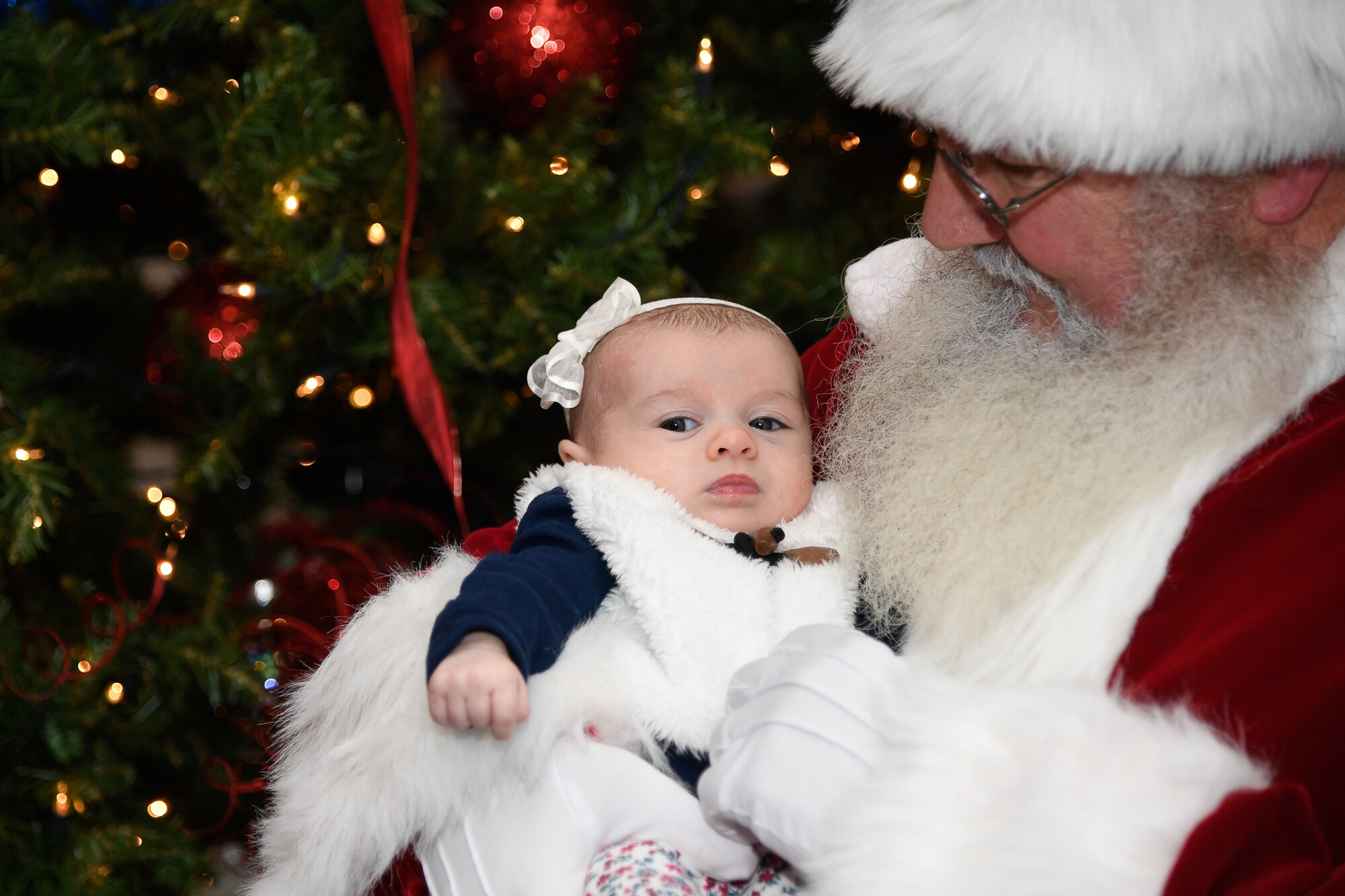 Santa Claus holds 10-week-old Lia Silvonic at the 66th Air Base Group holiday luncheon Dec. 7.