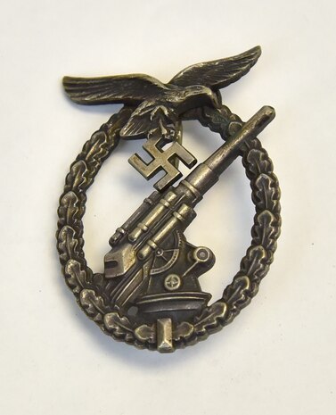 Plans call for this artifact to be displayed near the B-17F Memphis Belle™ as part of the new strategic bombardment exhibit in the WWII Gallery, which opens to the public on May 17, 2018. Luftwaffe (German Air Force) antiaircraft gunner uniform badge.  Bomber crews faced deadly antiaircraft, or “flak,” defenses.